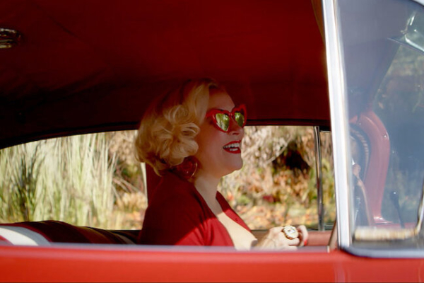 Jennifer Tilly as Tiffany Valentine driving a vintage red car